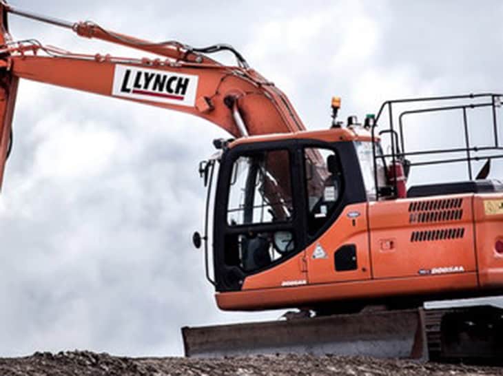 Excavator with Lynch branding used in construction site for erosion control and stormwater managemen.